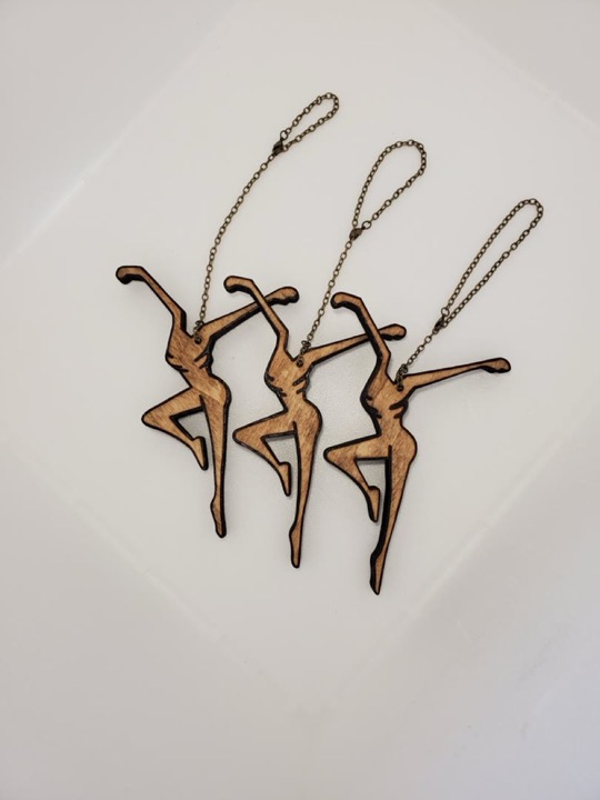 Three cut-wood dancer ornaments by Journey Hallows