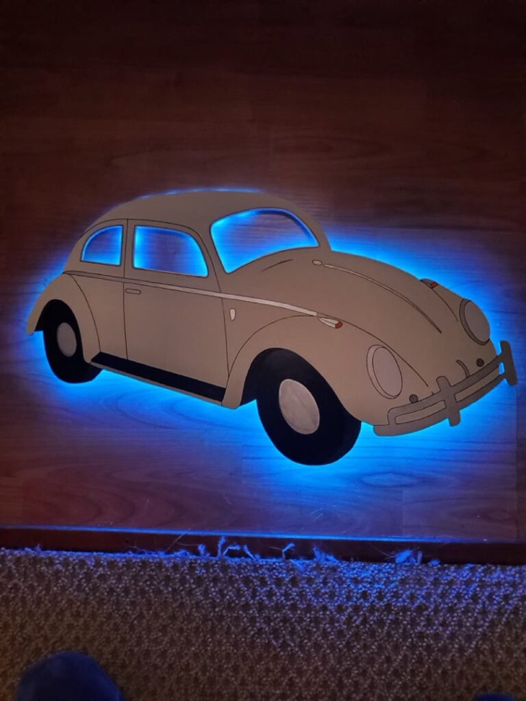 Vintage Volkswagen Beetle wall piece with bright blue backlighting