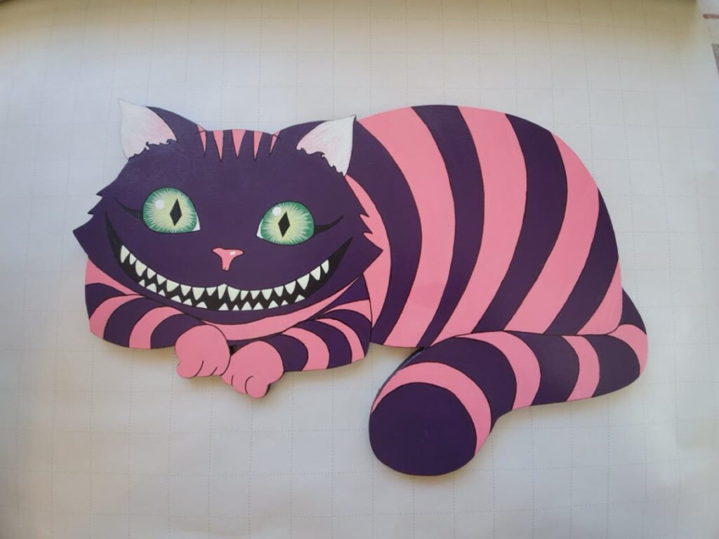 Painted purple and pink Cheshire Cat dimensional wall piece