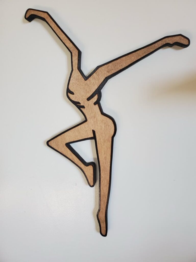 Cut-wood dancer silhouette displayed on a wall