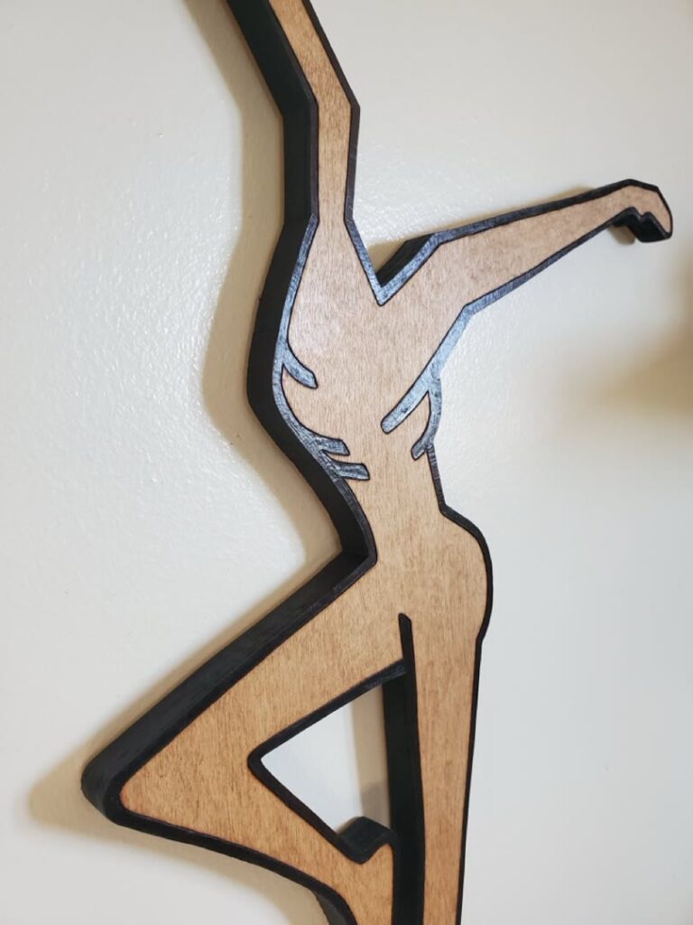 Close view of the burned edge and wood grain on a dancer silhouette