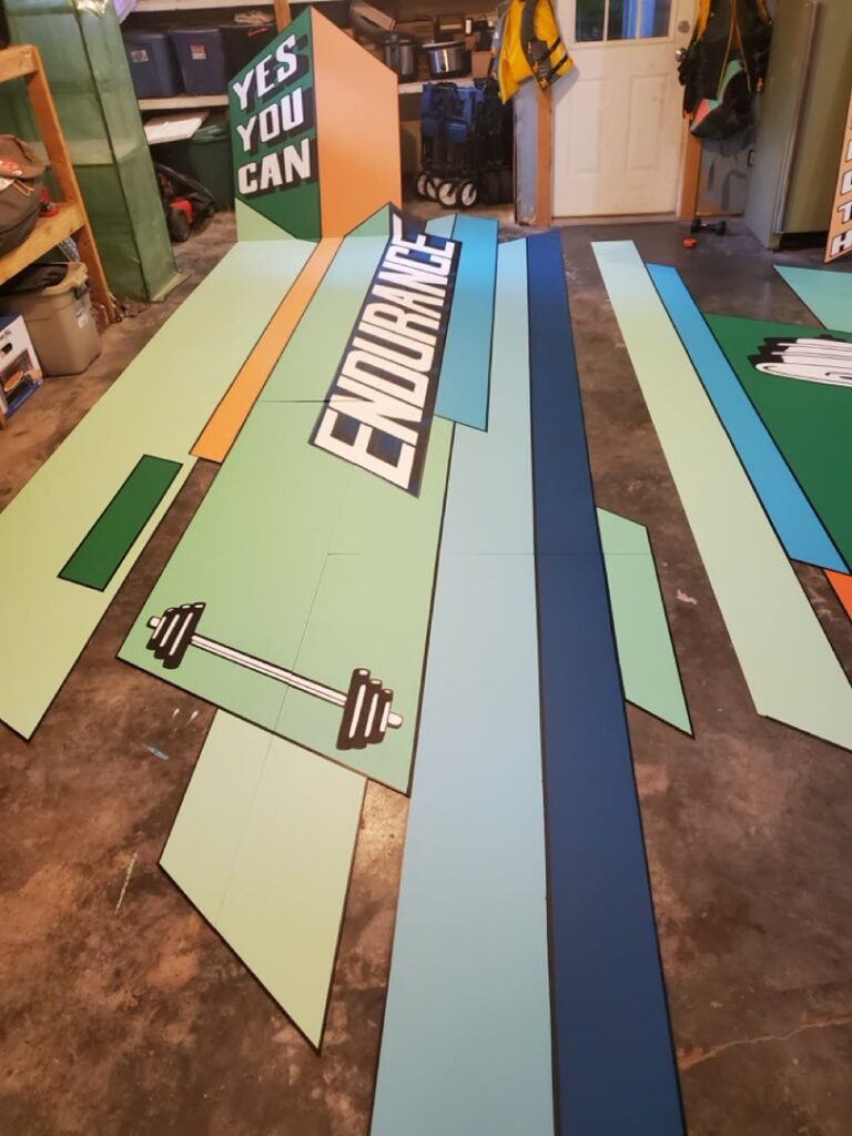 Painted Endurance mural panels arranged on a workshop floor