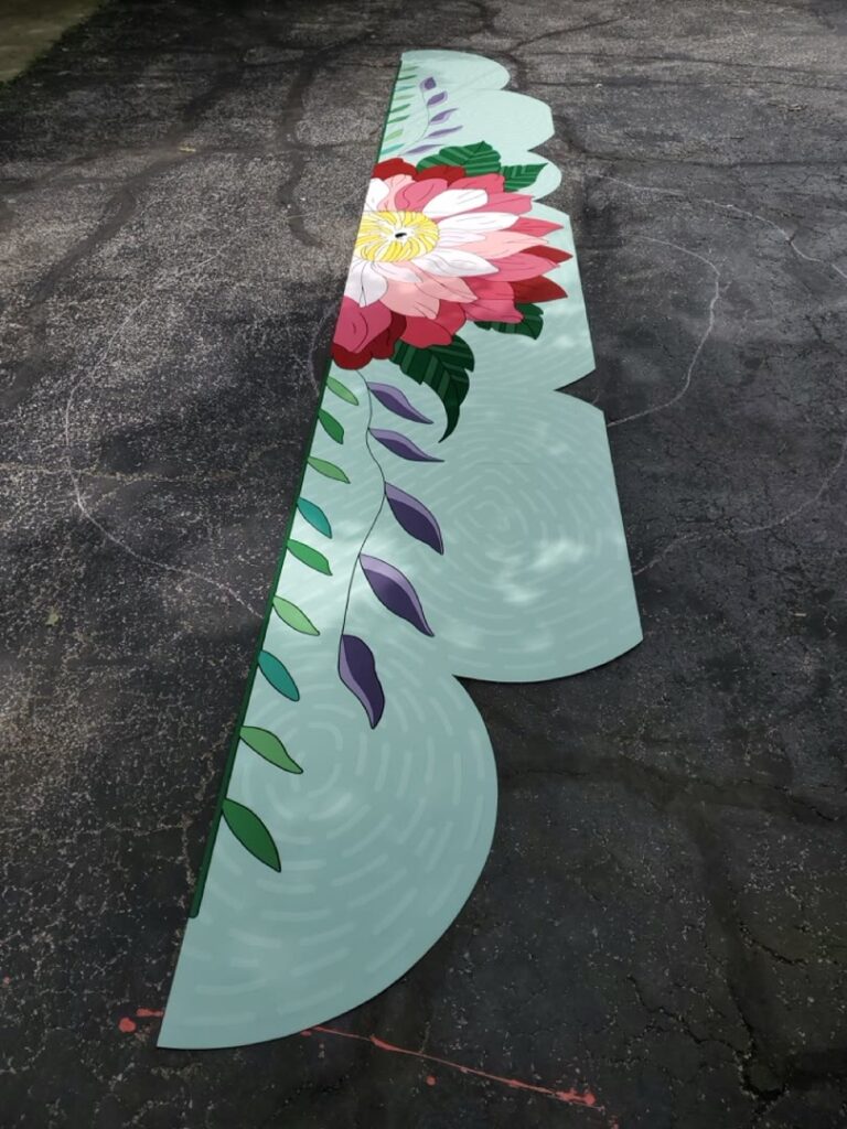 Long floral mural panels laid out outdoors before installation