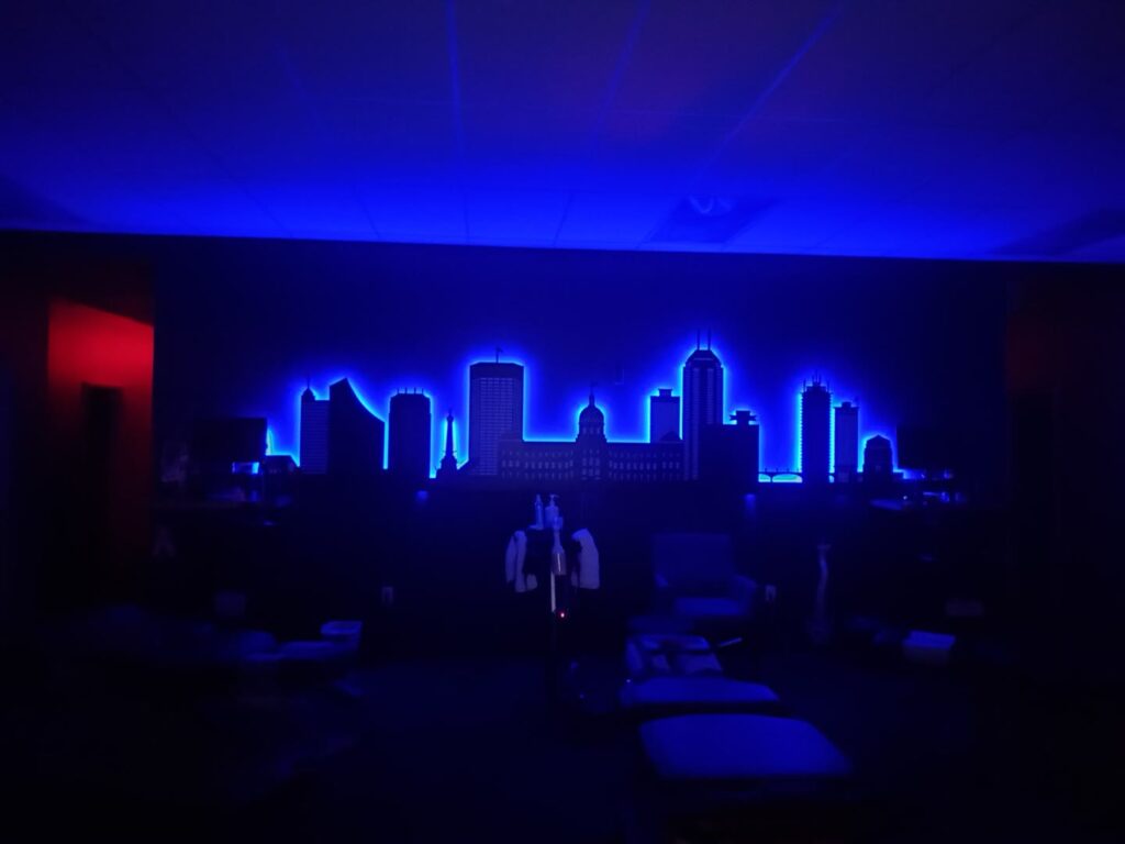 Indianapolis skyline wall piece glowing blue in a dark room