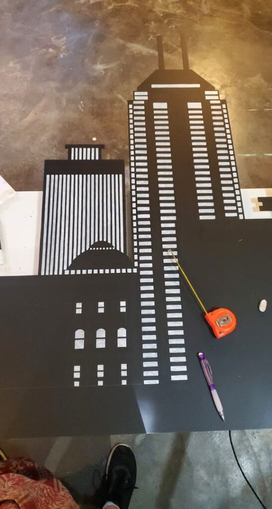 Close view of cut and painted Indianapolis skyline panels in progress