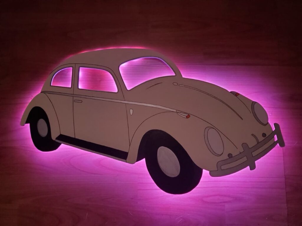 Vintage Volkswagen Beetle wall piece with pink backlighting