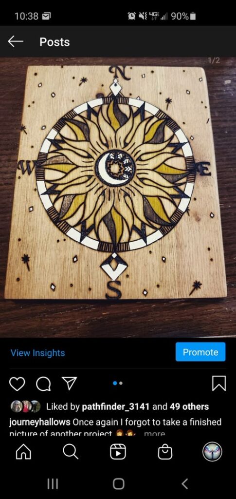 Hand-burned compass design with sun and moon imagery on a rectangular wood panel