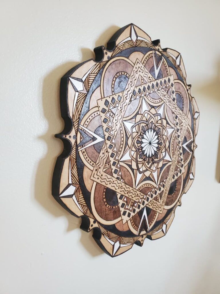 Angled view showing the depth of a geometric wood mandala